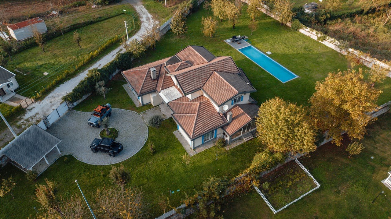 Services Drone view of a spacious modern house with a pool, set in rural İzmit, Turkey.