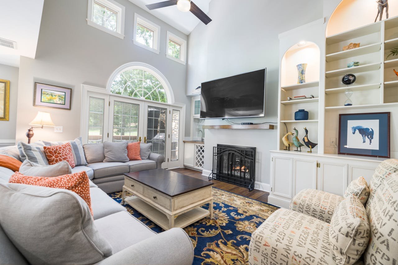 Home Cozy modern living room featuring a fireplace, large TV, and stylish decor, perfect for relaxation.